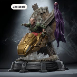 May include: A detailed statue featuring a bald character in a green jacket riding a gold vehicle. A purple cape and helmet are behind him. The base is dark gray with a signature. The word "Bestseller" is in a white oval.