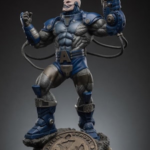 May include: A detailed statue of Apocalypse, a Marvel Comics supervillain, in a dynamic pose. The figure is predominantly blue and silver, with intricate armor and a weapon. The base features a bronze-colored emblem and skulls, adding to the character's imposing presence.