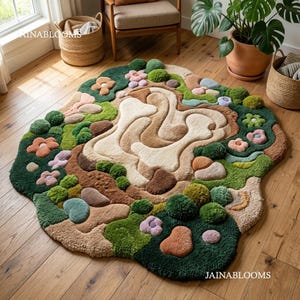 May include: A colourful, tufted rug with a landscape design. The rug features green, brown, beige, and pink elements, with flower and stone-like shapes. The rug is placed on a wooden floor, creating a natural and inviting atmosphere. The rug is a unique home decor item.