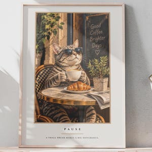 May include: A framed wall art print featuring a tabby cat wearing sunglasses, sitting at a cafe table with a coffee cup, a croissant, and a newspaper. The text reads Good Coffee Brighter Days, PAUSE, and A SMALL BREAK MAKES A BIG DIFFERENCE.