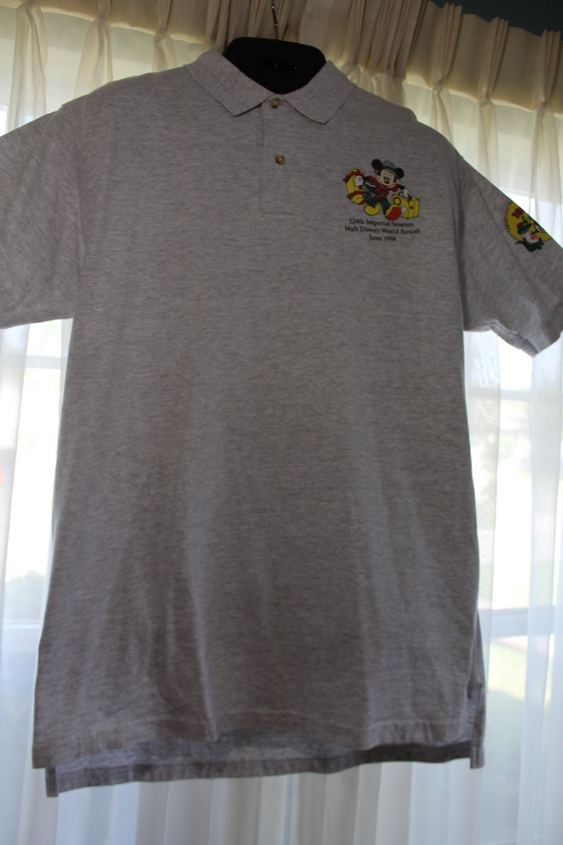 May include: A gray polo shirt with a Mickey Mouse graphic and the text "12th Annual Imperial Senators Walt Disney World Resort June 1998".