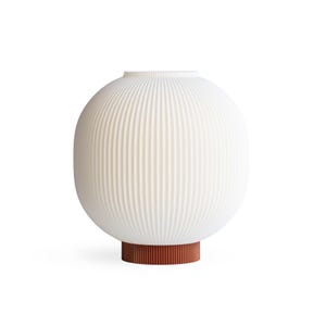 May include: A white, ribbed, spherical lamp with a cylindrical, reddish-brown base. The lamp has a rounded shape and a textured surface. The design is modern and minimalist, suitable for home decor.
