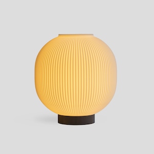 May include: A modern, spherical table lamp with a ribbed, off-white shade. The lamp sits on a dark brown, cylindrical base. The lamp emits a warm, inviting glow, perfect for ambient lighting in a living room or bedroom.
