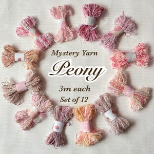 May include: A set of 12 Peony mystery yarn bundles, each 3 meters long. The yarn is a mix of pink, peach, and white colors. Each bundle is wrapped with a decorative paper band.
