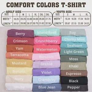 May include: A display of Comfort Colors T-shirts in various colors, including Berry, Crimson, and Yam. The image includes a size chart for adult and youth sizes, with width and length measurements in inches.