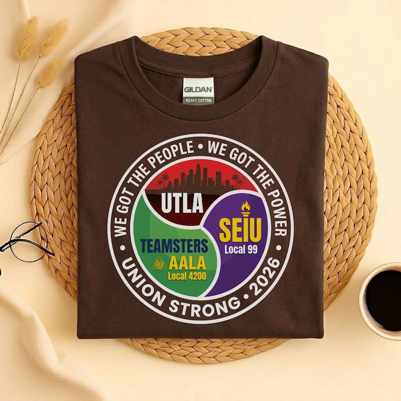 May include: A brown t-shirt with a circular graphic featuring the text "WE GOT THE PEOPLE WE GOT THE POWER" and "UNION STRONG 2026". The graphic includes the logos for UTLA, Teamsters AALA Local 4200, and SEIU Local 99.