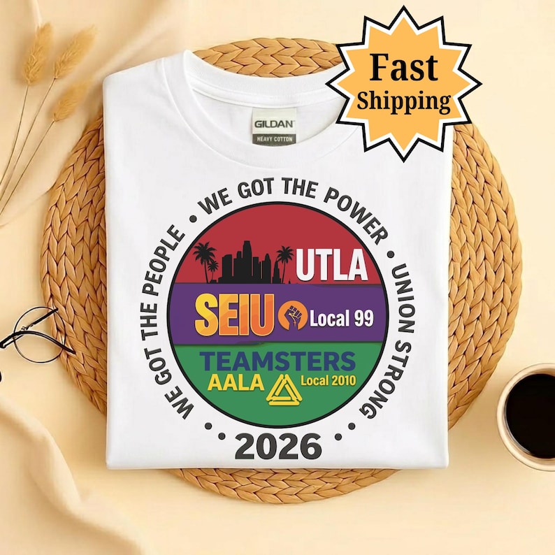 May include: White t-shirt with a circular graphic featuring text and logos. The graphic includes the words "WE GOT THE POWER", "UTLA", "SEIU Local 99", "TEAMSTERS AALA", and the year "2026". A "Fast Shipping" sticker is in the top right corner.