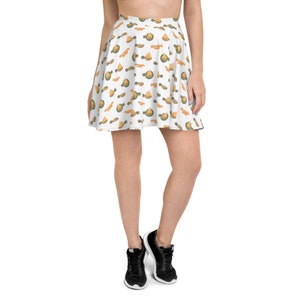 May include: A white skater skirt with a pattern of yellow pineapples and green leaves. The skirt is pleated and has a high waist.