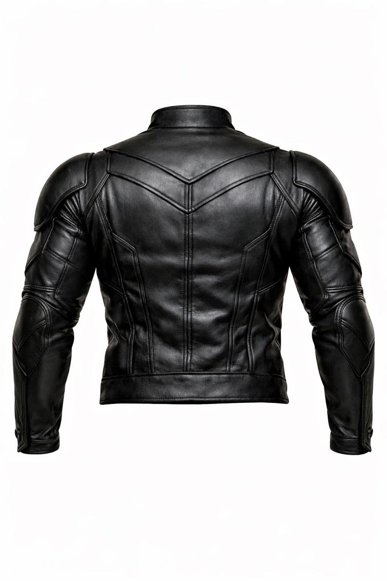 May include: Black leather jacket with a stand-up collar and quilted shoulder and arm details. The back of the jacket features a series of vertical and angled seams, creating a textured appearance. The jacket has a tailored fit.
