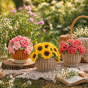 May include: Three crochet flower arrangements in baskets. One features pink flowers, another yellow sunflowers, and the third red roses. The baskets are brown and beige, set on a wooden surface with a natural background.