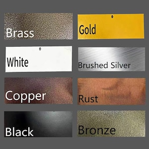 May include: A collection of color swatches, each labeled with a different metallic or solid color. Colors include brass, gold, white, brushed silver, copper, rust, black, and bronze. The labels are in a sans-serif font.