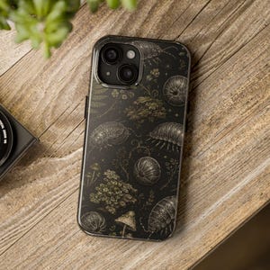 May include: A black smartphone case featuring a detailed botanical and entomological pattern. The design includes illustrations of woodlice, small mushrooms, ferns, and tiny stars in shades of gold and white against a dark background.