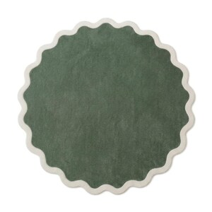 May include: A circular rug featuring a deep forest green center with a textured, soft-looking surface. The rug is framed by a distinct, wide scalloped border in a contrasting off-white or cream color, creating a wavy edge around the entire perimeter.