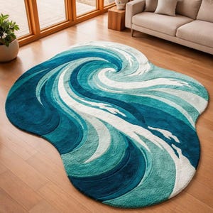 May include: An irregularly shaped area rug featuring a swirling ocean wave design in shades of deep navy, teal, and bright turquoise, accented with white foam patterns that curve across the textured surface to create a dynamic, flowing visual effect.