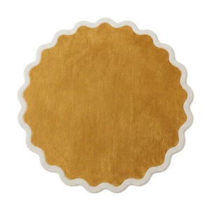 May include: A circular rug featuring a solid mustard yellow center with a soft, textured pile. The rug is framed by a distinct, scalloped edge border in a contrasting off-white color, creating a wavy, decorative outline around the entire perimeter.