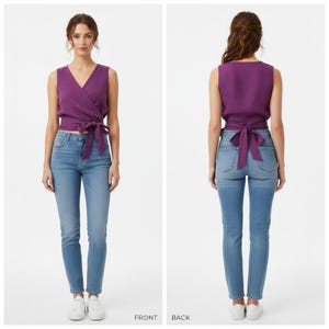 May include: A sleeveless purple wrap top featuring a V-neckline and a side tie closure at the waist, paired with light blue denim jeans. The garment is shown from both the front and back views, highlighting the wrap design and the tied bow detail.