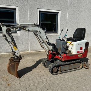 May include: A small, red, white, and grey mini excavator with a black seat and caterpillar tracks. The excavator features a metal bucket and arm, control levers, and an engine compartment. The model number "TB108" is visible.