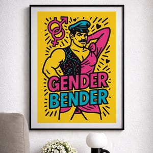 Puede incluir: Una impresión artística enmarcada con un fondo amarillo que presenta una ilustración estilizada de una persona con un atuendo rosa y negro. El texto "GENDER BENDER" está en rosa y azul. La obra incluye símbolos de género y corazones.