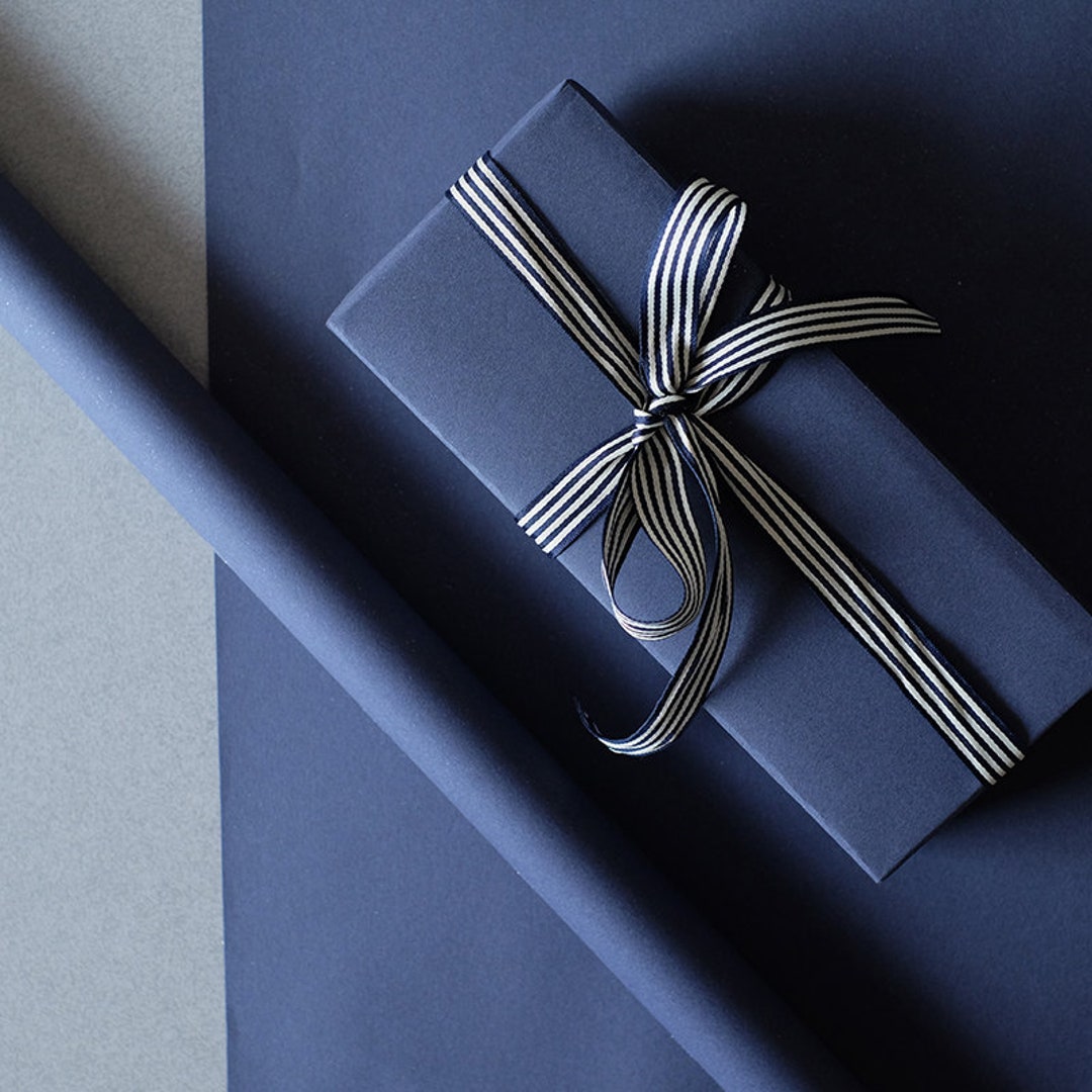 Gift wrapping presents on dark blue table. Stock Photo by ©amarosy 91746514