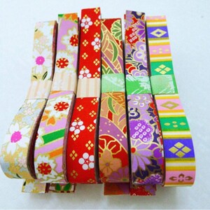 May include: Assortment of colorful washi tape rolls with various floral and geometric patterns. The tape is made of paper and is perfect for adding a touch of color and style to crafts, gifts, and home decor.