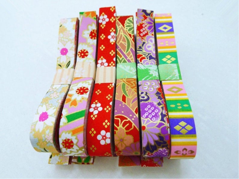 May include: Assortment of colorful washi tape rolls with various floral and geometric patterns. The tape is made of paper and is perfect for adding a touch of color and style to crafts, gifts, and home decor.
