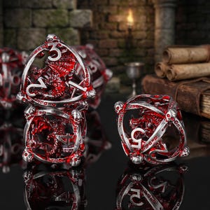 Könnte beinhalten: Satz roter und silberner Fantasy-Würfel mit Drachen- und Totenkopfmotiven. Die Würfel bestehen aus einem transluzenten roten Material mit silbernen Akzenten und weisen aufwendige Drachen- und Totenkopfdetails auf. Ideal für Tabletop-Gaming.
