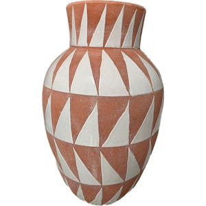 May include: A terracotta-colored vase with a geometric pattern of white triangles. The vase has a wide, rounded body that tapers to a narrower neck and flared rim. The design is symmetrical and creates a striking visual contrast.