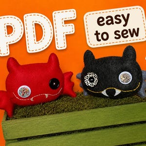 May include: Two plush monster toys, one red and one black, featuring button eyes and stitched fangs. The red monster has a patterned button and a black button for eyes. The black monster has a patterned button and a white button for eyes. Text reads PDF easy to sew.