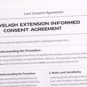 May include: A printed document titled "EYELASH EXTENSION INFORMED CONSENT AGREEMENT." The document includes sections on understanding the procedure and risks, with text about eyelash extensions and professional adhesive.
