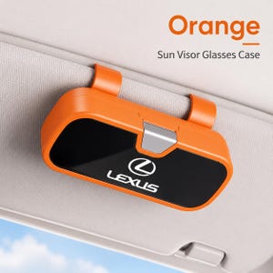 May include: An orange sun visor glasses case featuring the Lexus logo and text on a black front panel. The case has a silver latch mechanism and is attached to a vehicle sun visor. The text Orange Sun Visor Glasses Case is visible above.