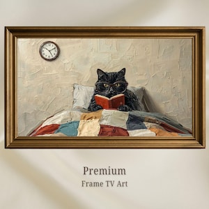 May include: A framed digital artwork depicting a black cat wearing glasses and reading a small red book while tucked into a patchwork quilt. A round analogue clock hangs on the textured beige wall behind the cat. The frame is a metallic bronze colour.