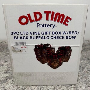 May include: A white box with the "OLD TIME Pottery" logo and text. The box contains three vine gift boxes with red and black buffalo check bows. The text on the box reads "3PC LTD VINE GIFT BOX W/RED/ BLACK BUFFALO CHECK BOW."