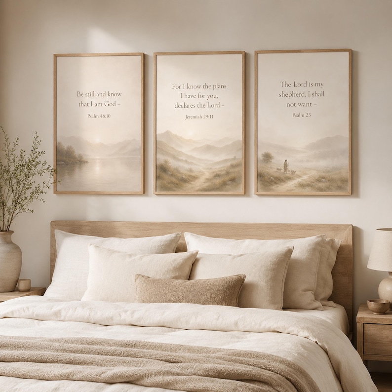 May include: Three rectangular wall art prints in light wood frames featuring beige landscape scenes with misty mountains and water. Each print displays religious text: Psalm 46:10, Jeremiah 29:11, and Psalm 23, written in a simple dark font.