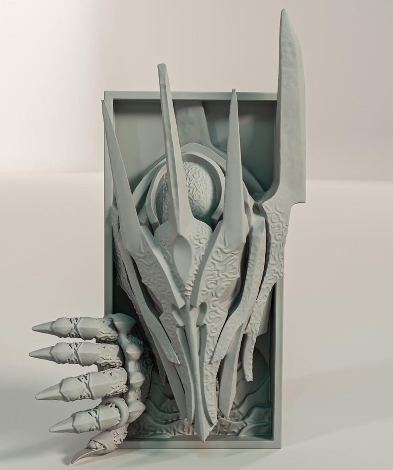 May include: A light grey, 3D-printed wall art piece with an abstract, stylised design. The artwork features sharp, elongated elements and a detailed, textured surface. The design has a central, organic shape with a claw-like appendage.
