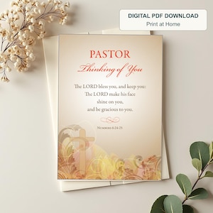 May include: A rectangular card with a beige gradient background featuring the text PASTOR Thinking of You and the Bible verse Numbers 6:24-25. The design includes a faint cross and swirling floral patterns in shades of orange and brown.