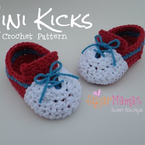 May include: A pair of crocheted baby shoes in red, white, and blue. The shoes have a lace-up design and are tied with a blue ribbon. The shoes are labeled "Mini Kicks Crochet Pattern".
