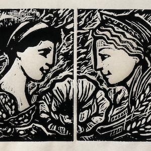 May include: Black and white woodcut print of two women's faces, each framed by floral motifs. The women are looking at each other, and the print has a romantic and whimsical feel.