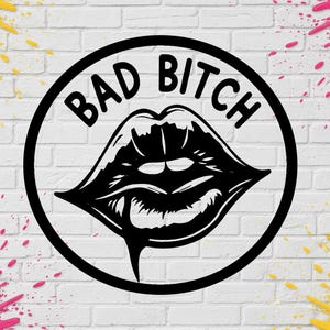 May include: Black and white graphic of a pair of lips with a drop of liquid, inside a black circle. The words "BAD BITCH" are in a semi-circle above the lips. The background is a white brick wall with pink and yellow paint splatters.