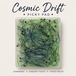 May include: A rectangular Cosmic Drift Picky Pad sensory fidget featuring a translucent light green base embedded with numerous thin, dark blue fibers and small black spherical beads scattered throughout the surface for tactile interaction.