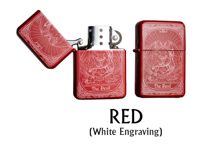 May include: Red lighter with white engraving featuring a detailed illustration of a devil figure. The lighter is shown open and closed, with the text "The Devil" on the front. The word "RED" is displayed below the lighters.