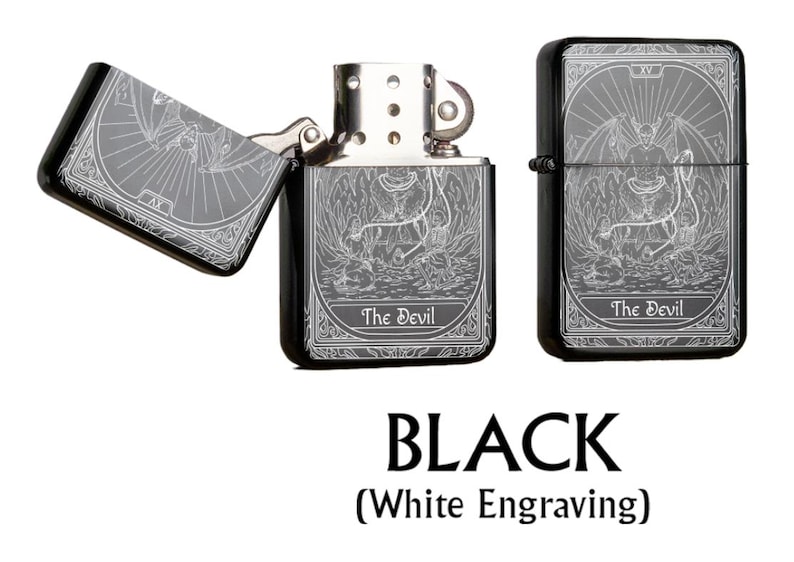 May include: Black metal lighter with white engraving featuring a tarot card design. The lighter is shown open and closed, with the text "The Devil" visible. The image also includes the word "BLACK" and "(White Engraving)".