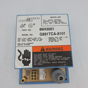 May include: A blue Johnson Controls ignition control module, model G891TCA-8101, part number 86H3001. The label displays technical specifications, a warning about electrical shock hazards, and indicator light instructions. A six-pin connector and a gray component are visible at the base.