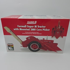 May include: A red and white rectangular cardboard box for a 1/16 scale Farmall Super M Tractor with Mounted 2MH Corn Picker. The box features the Case IH logo, product text, and an illustration of the red tractor with a long beige elevator.