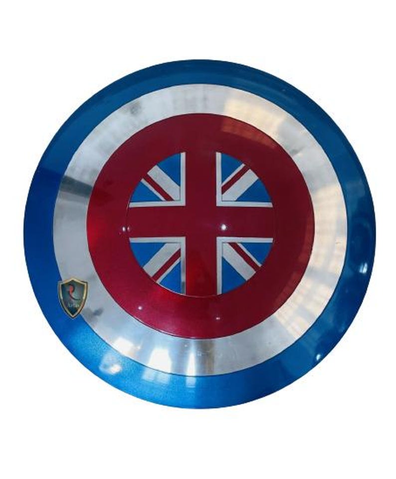 May include: A round shield with a blue, silver, and red color scheme. The shield features a Union Jack design at the center, with a blue outer ring and a silver inner ring. A small emblem is visible on the left side.