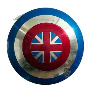 May include: A round shield with a blue outer ring, a silver middle ring, and a red center. The center features a Union Jack design. The shield has a metallic sheen and a white background.