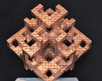 May include: A geometric copper sculpture with a repeating pattern of diamond shapes. The sculpture is displayed on a white pedestal against a black background. The artwork has a three-dimensional, open design.