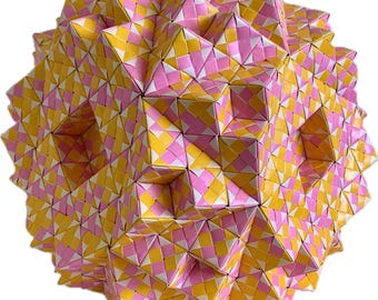 May include: A geometric, spherical sculpture composed of numerous folded paper modules. The modules are arranged in a repeating pattern of yellow, pink, and white diamond shapes, creating a textured, three-dimensional effect. The overall form is a complex, multi-faceted sphere.