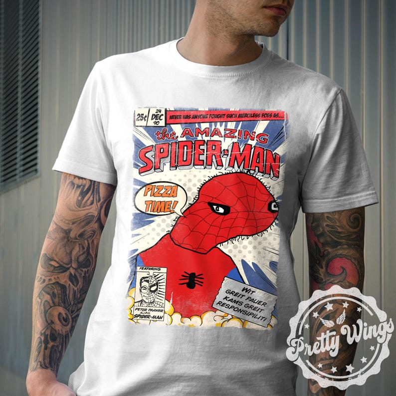 May include: White t-shirt featuring a comic book-style graphic of Spider-Man with the text "PIZZA TIME!". The design includes the words "THE AMAZING SPIDER-MAN" and other text in a comic book layout. The shirt has a crew neck.