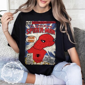 May include: Black t-shirt featuring a comic book-style graphic of Spider-Man with the text "PIZZA TIME!". The design includes the words "the AMAZING SPIDER-MAN" and other comic book elements.