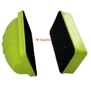 May include: Two neon green magnetic window cleaners with black scrubbing pads. The cleaners have a rectangular shape with rounded edges and a grooved handle for grip. The text "NY-Supplies" is visible in the image.